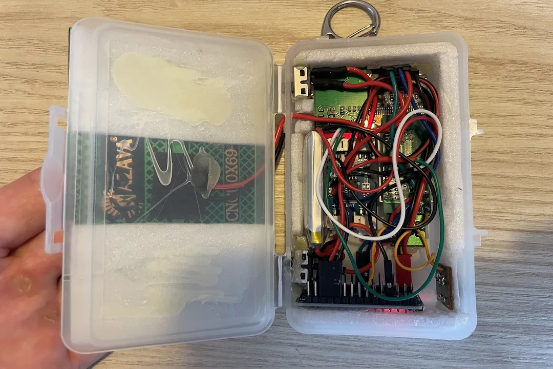 Internal view of the GPS tracker showing the solar circuit, Arduino Nano, and GPS module